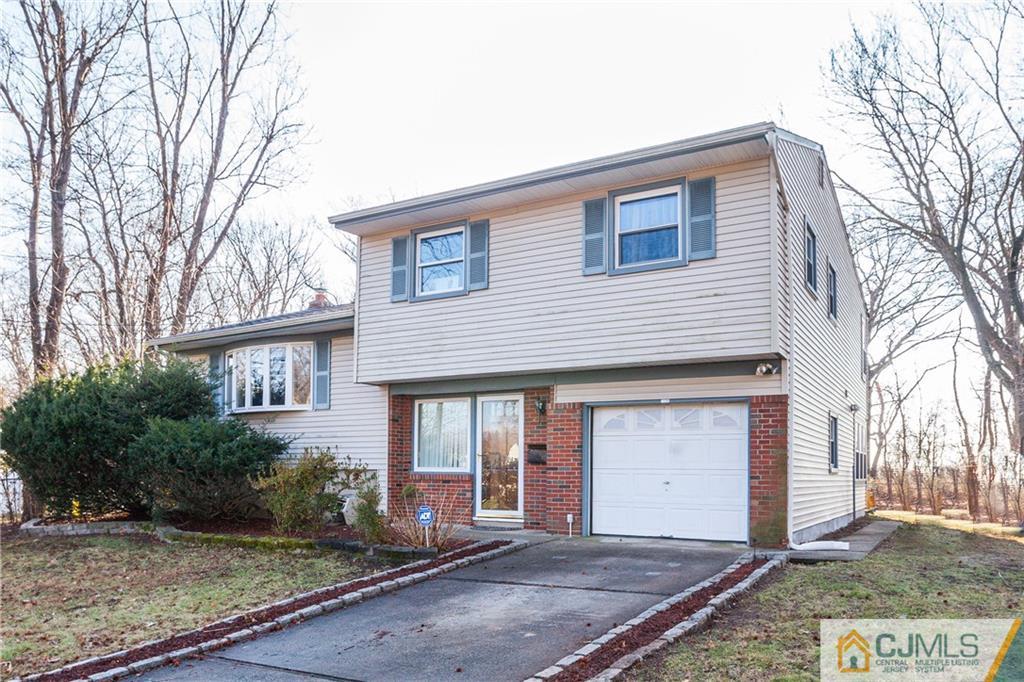 4 Laythan Road Edison, NJ 08817 - Photo 1 of 25 a front view of a house with a garden