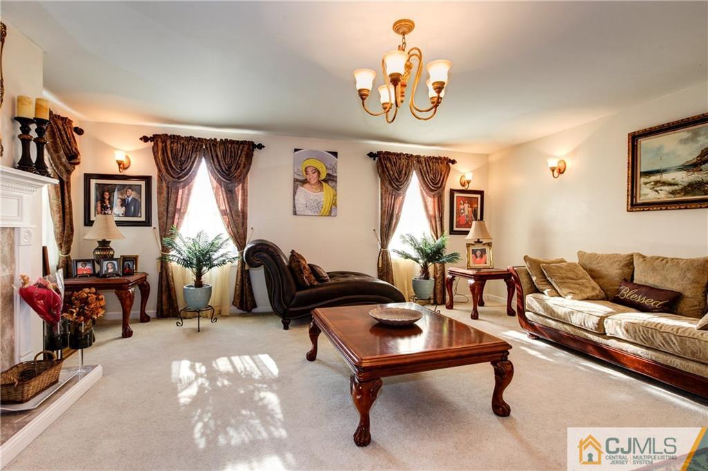 4 Laythan Road Edison, NJ 08817 - Photo 3 of 25 a living room with furniture a flat screen tv and a table