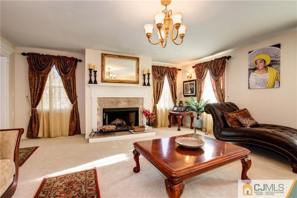 4 Laythan Road Edison, NJ 08817 - Photo 4 of 25 a living room with furniture and a fireplace