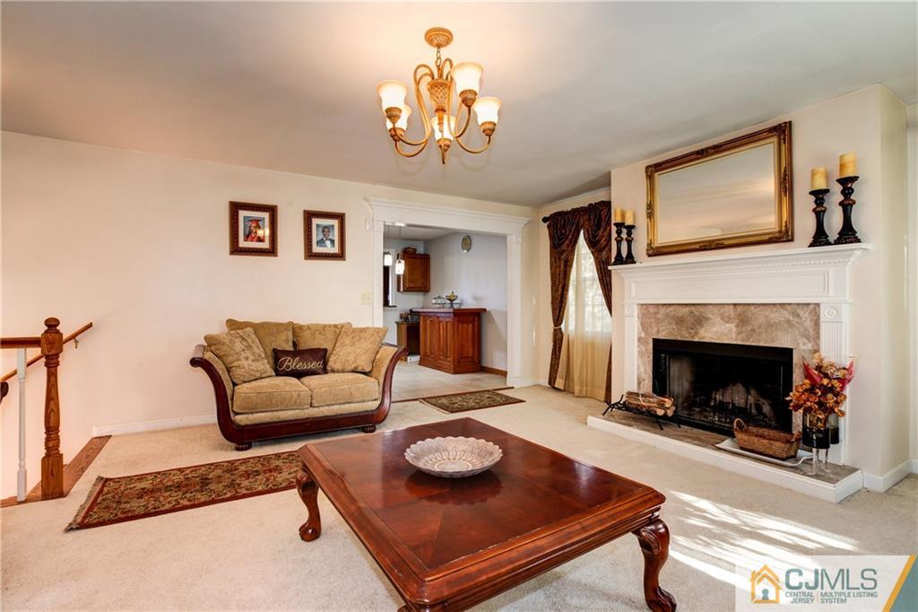 4 Laythan Road Edison, NJ 08817 - Photo 5 of 25 a living room with furniture and a fireplace