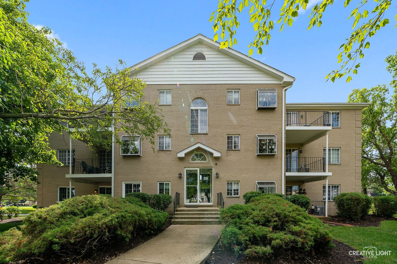 1258 Chalet Road, Unit 104 Naperville, IL 60563 - Photo 1 of 14 front view of a house with a yard
