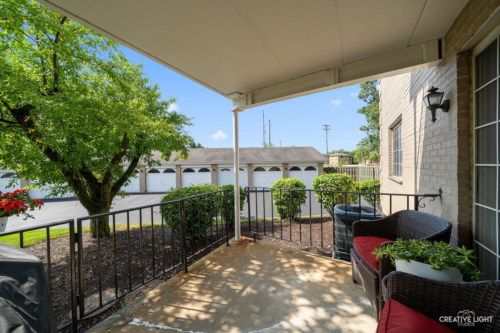 1258 Chalet Road, Unit 104 Naperville, IL 60563 - Photo 13 of 14 a view of a house with a large windows and flower plants