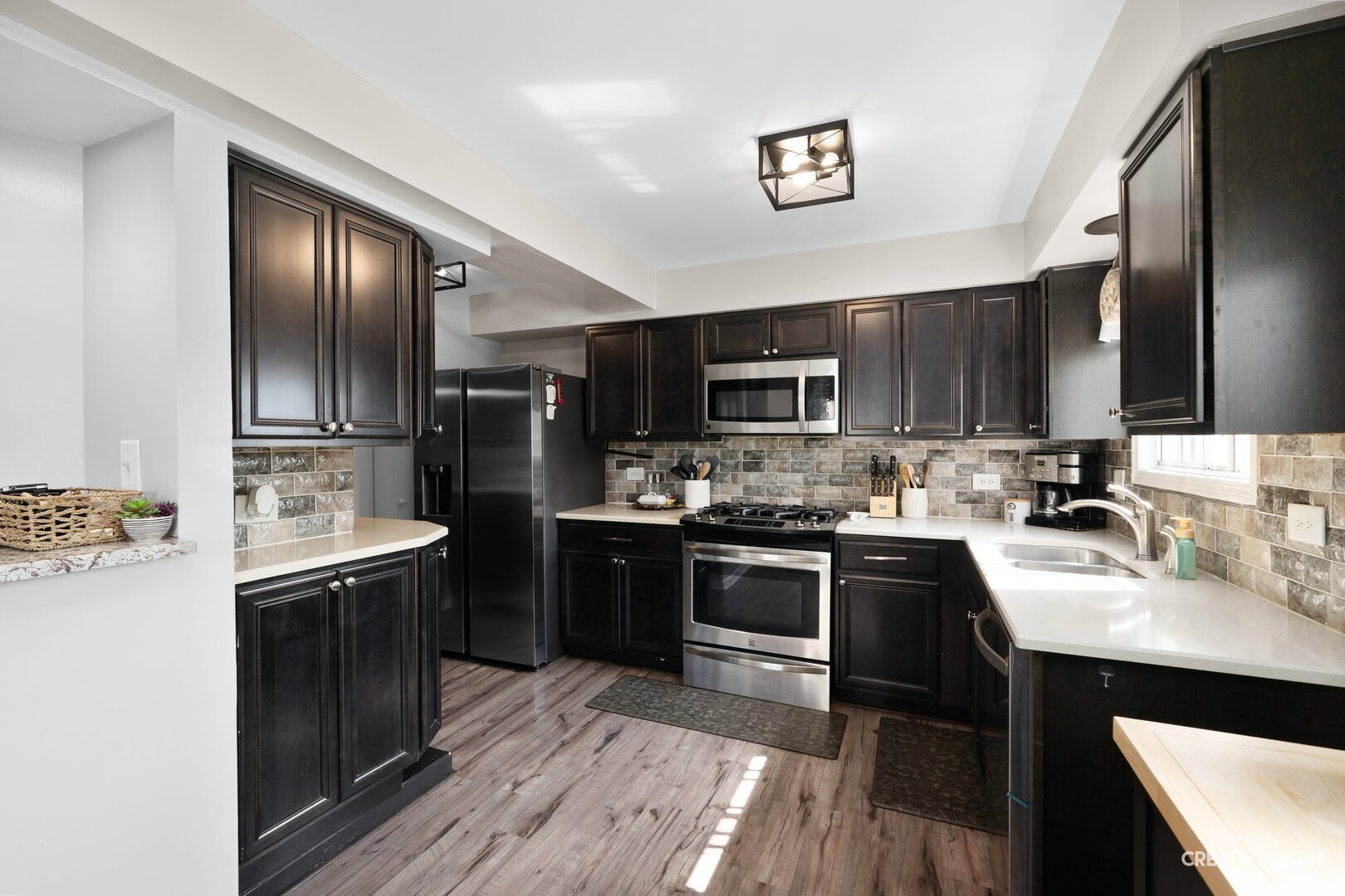 1258 Chalet Road, Unit 104 Naperville, IL 60563 - Photo 2 of 14 a kitchen with kitchen island granite countertop stainless steel appliances and sink
