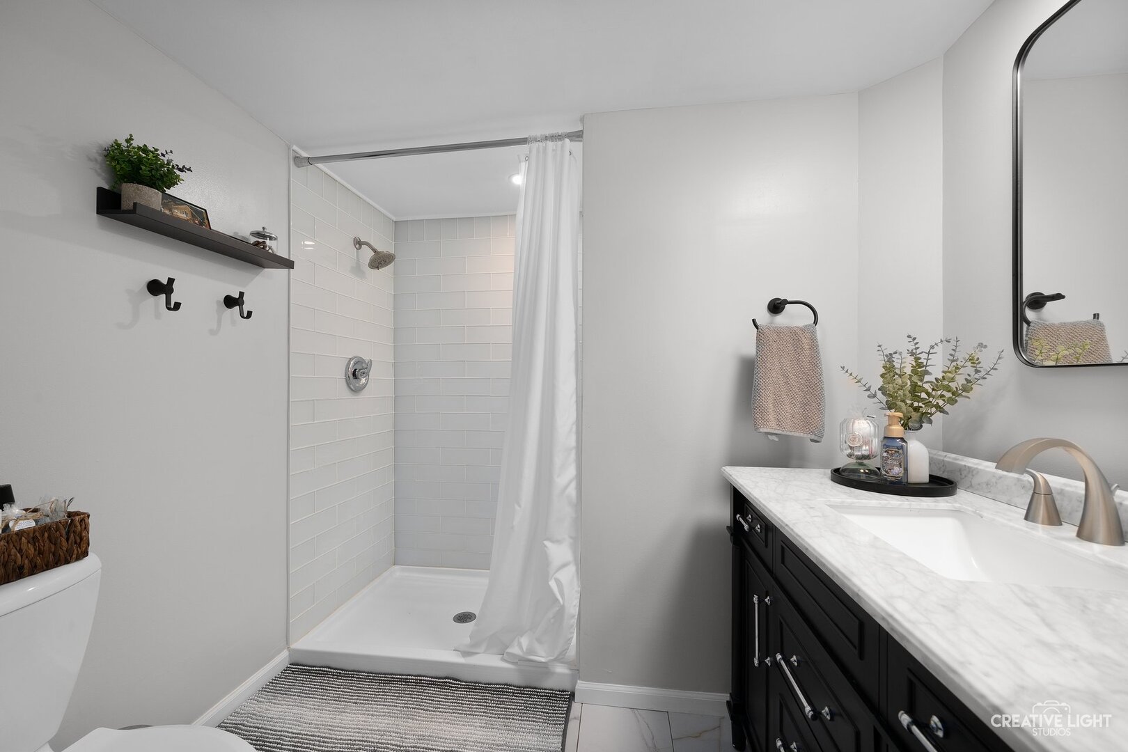 1258 Chalet Road, Unit 104 Naperville, IL 60563 - Photo 10 of 14 a bathroom with a shower sink and mirror