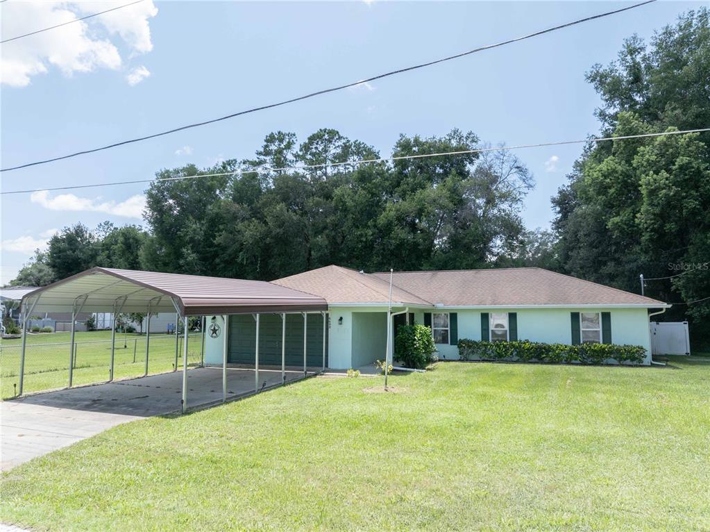 6690 Cherry Road Ocala, FL 34472 - Photo 1 of 1 a front view of a house with swimming pool