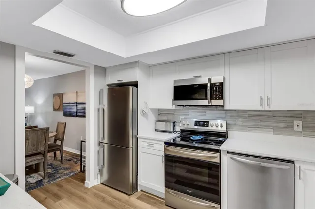 a kitchen with stainless steel appliances a refrigerator stove and microwave