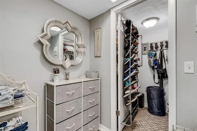 a view of walk in closet with clothes and shoes