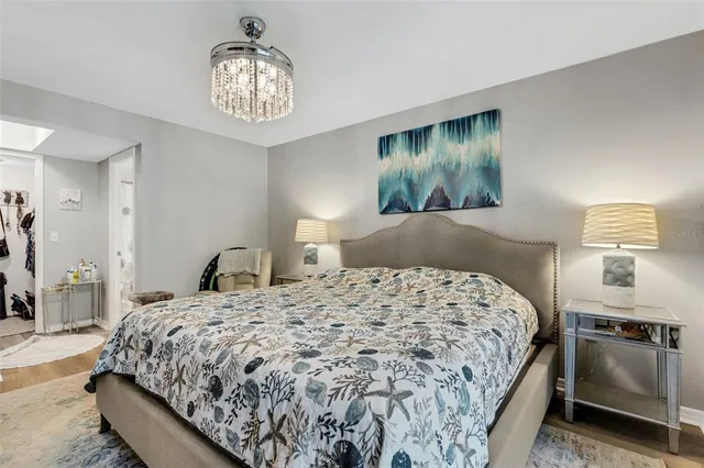 a bedroom with a bed and a chandelier