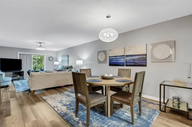 a view of a dining room with furniture and wooden floor