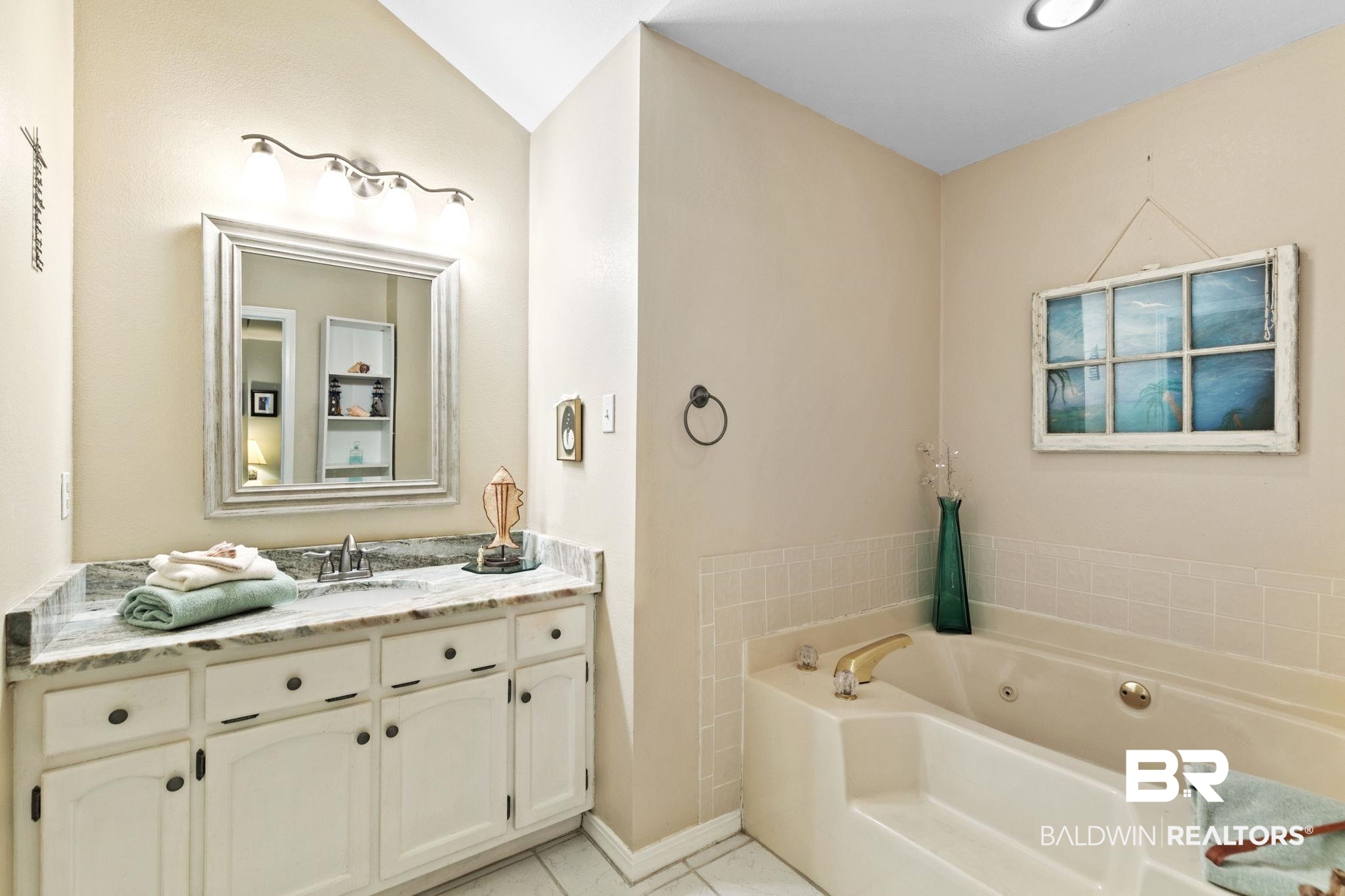 519 Juniper Place Drive Foley, AL 36535 - Photo 22 of 47 Bathroom with granite countertop, a jetted tub, and light tile patterned flooring