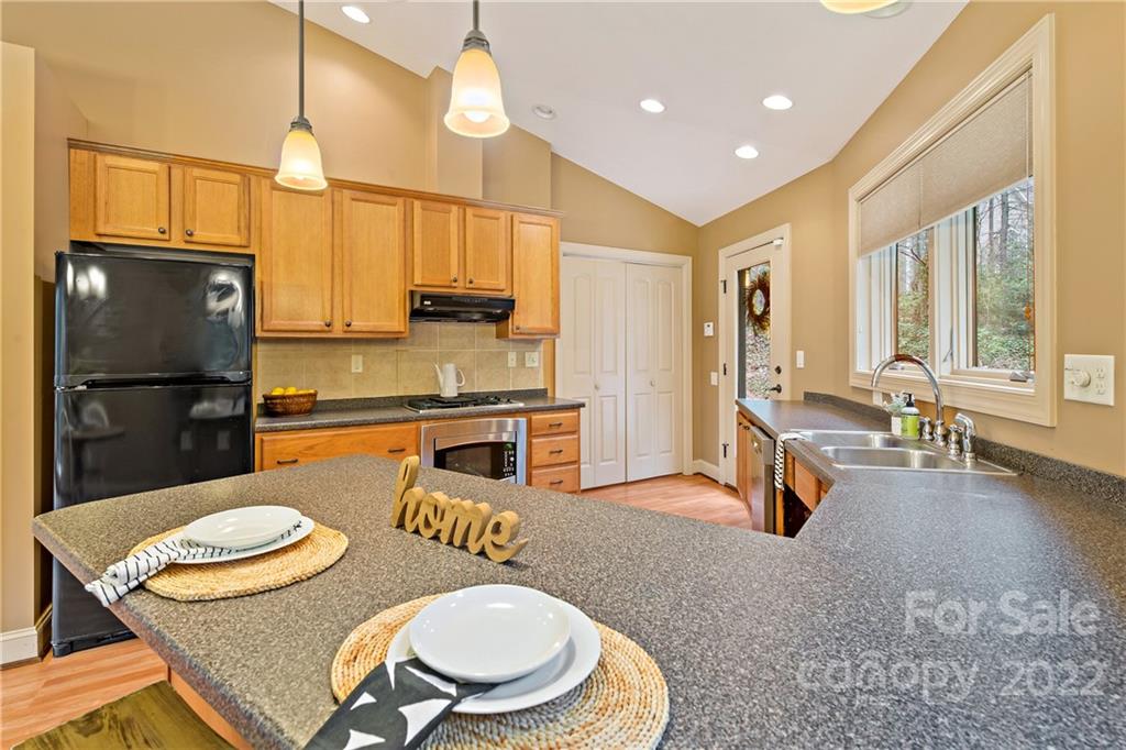 174 A Weston Road Arden, NC 28704 - Photo 11 of 31 a kitchen with stainless steel appliances granite countertop a sink a stove and refrigerator