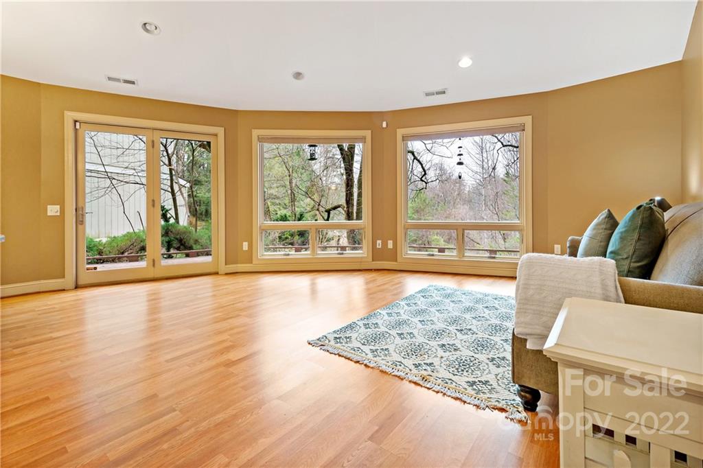 174 A Weston Road Arden, NC 28704 - Photo 19 of 31 a living room with furniture floor to ceiling window and wooden floor