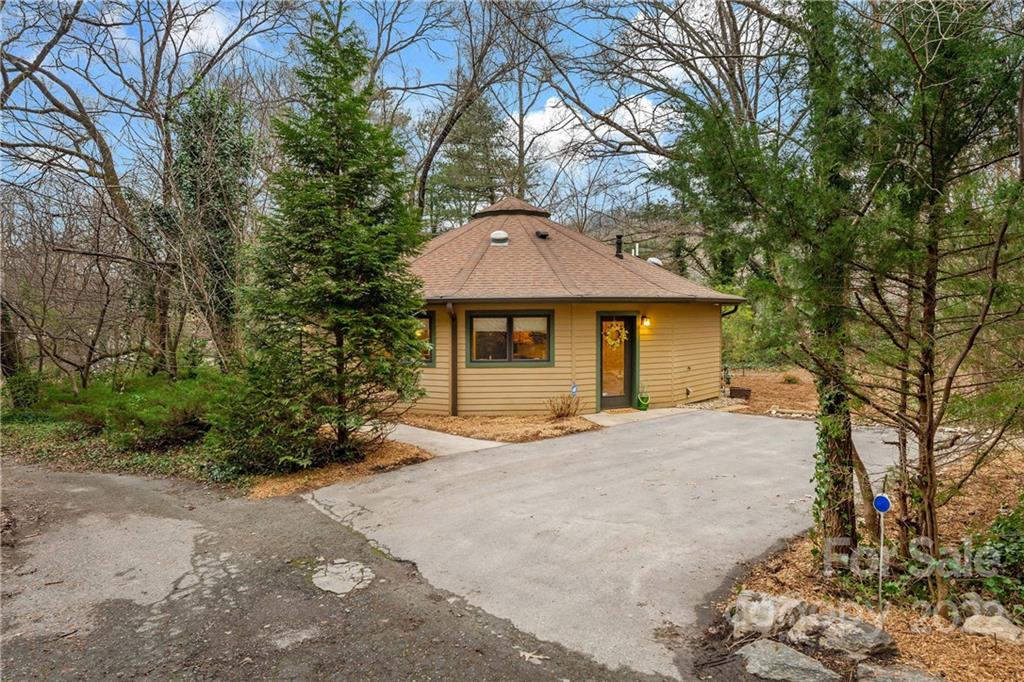 174 A Weston Road Arden, NC 28704 - Photo 2 of 31 a front view of a house with a garden and tree