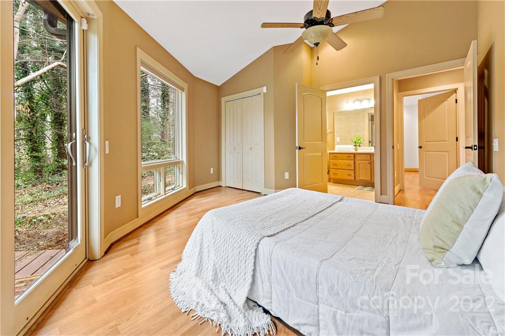 174 A Weston Road Arden, NC 28704 - Photo 21 of 31 a bedroom with a bed and a chandelier