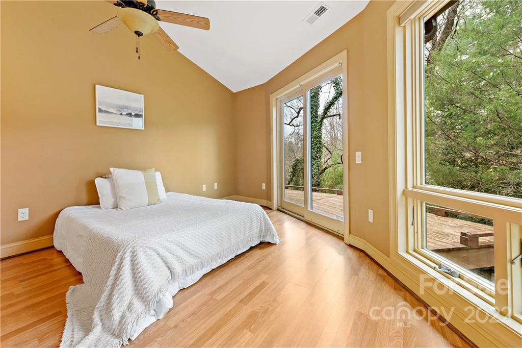 174 A Weston Road Arden, NC 28704 - Photo 22 of 31 a spacious bedroom with a bed and wooden floor