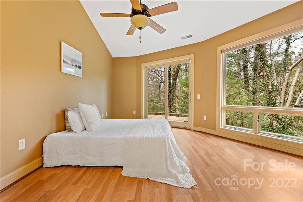 174 A Weston Road Arden, NC 28704 - Photo 23 of 31 a bedroom with a large bed and a large window
