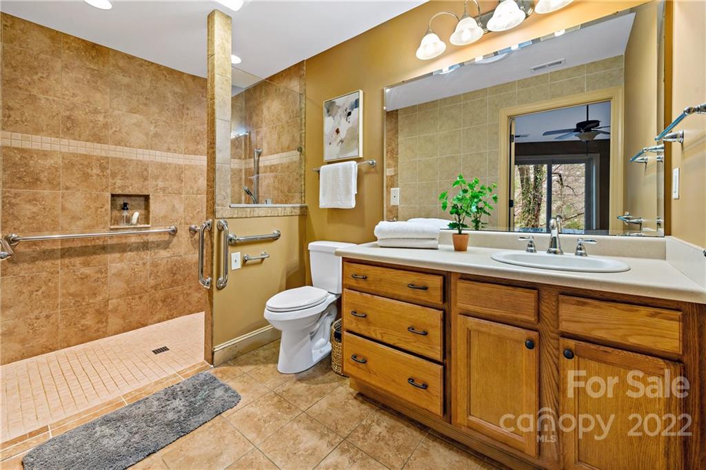 174 A Weston Road Arden, NC 28704 - Photo 24 of 31 a spacious bathroom with a double vanity sink a large mirror and a shower