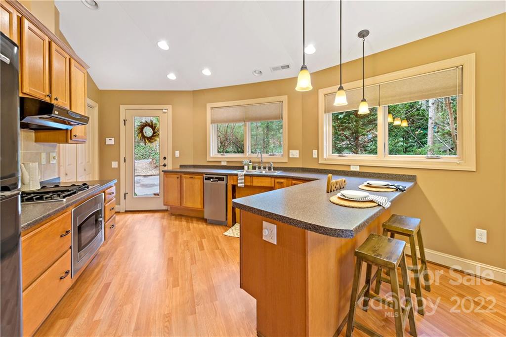 174 A Weston Road Arden, NC 28704 - Photo 10 of 31 a kitchen with stainless steel appliances granite countertop a stove and a wooden floors