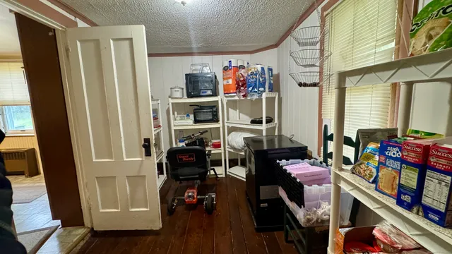 a view of a livingroom with furniture hardwood floor and windows
