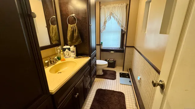 a bathroom with a tub sink and mirror