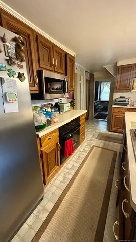 a kitchen with stainless steel appliances granite countertop a stove a sink dishwasher and a microwave