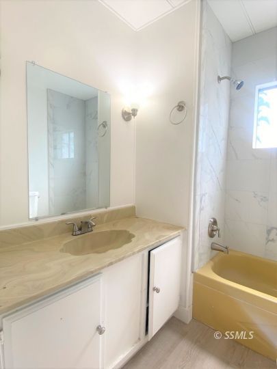 821 West Bennett Street Ridgecrest, CA 93555 - Photo 14 of 26 a bathroom with a granite countertop tub sink and mirror