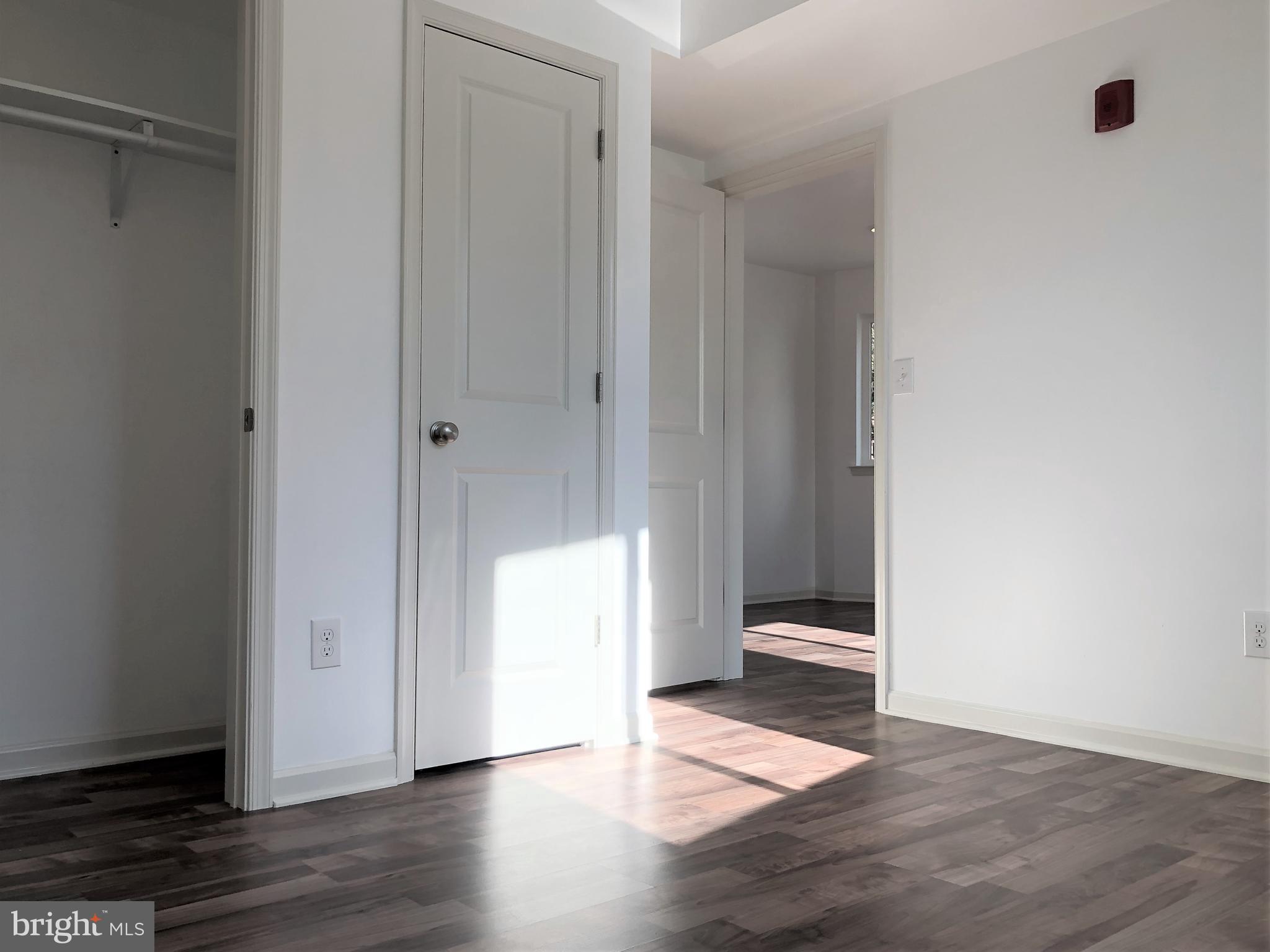 5261 Ridge Avenue, Unit 305 Philadelphia, PA 19128 - Photo 3 of 7 a view of an empty room with wooden floor