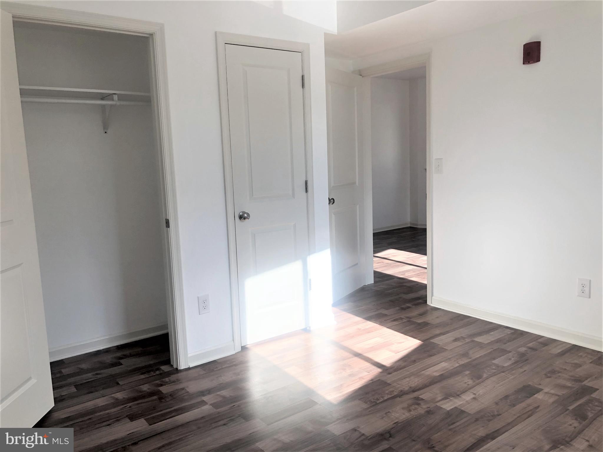5261 Ridge Avenue, Unit 305 Philadelphia, PA 19128 - Photo 6 of 7 a view of a hallway with wooden floor