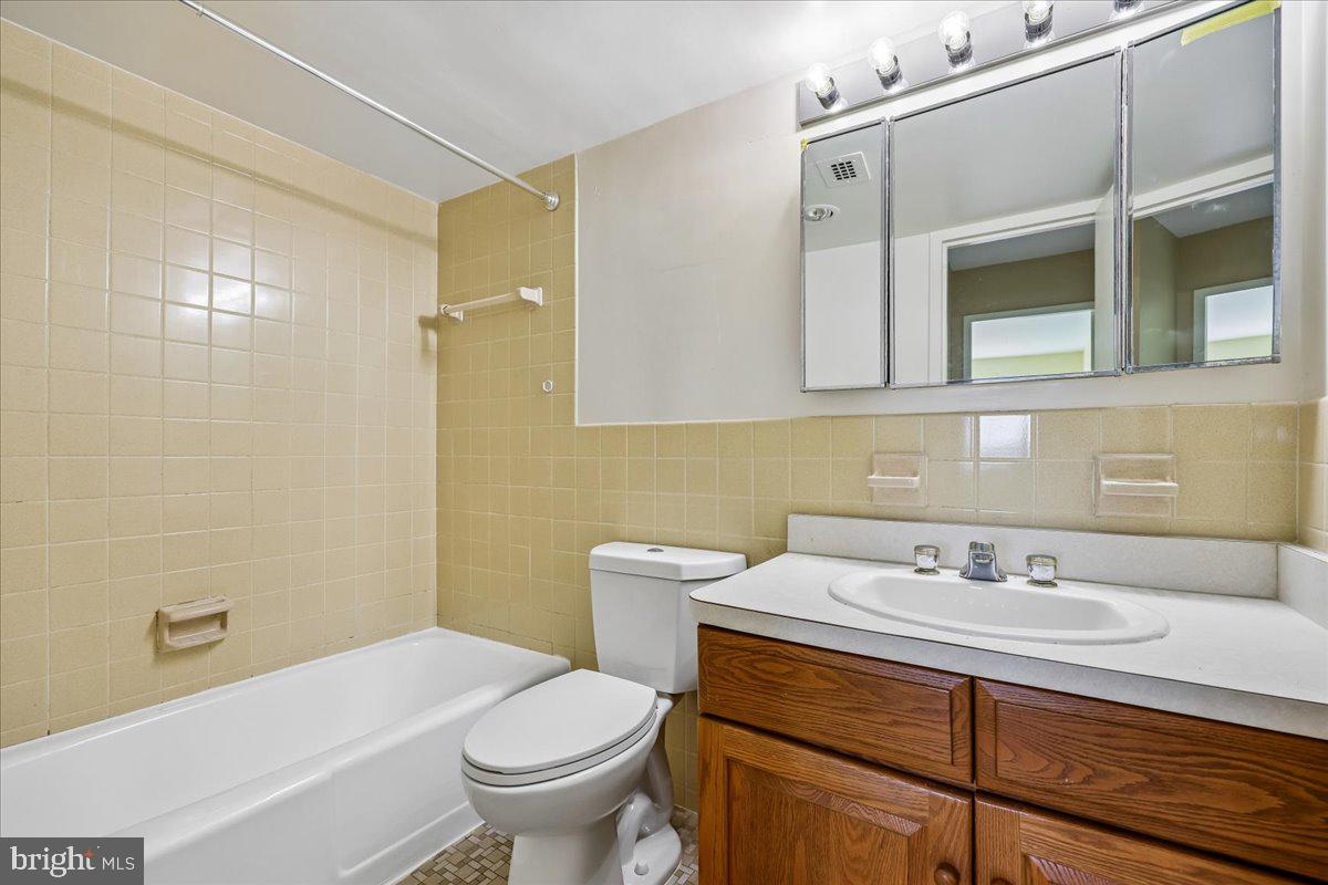 1111 University Boulevard West, Unit 1106A Silver Spring, MD 20902 - Photo 13 of 35 a bathroom with a sink a toilet and shower