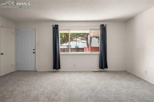 an empty room with large window