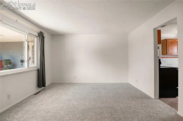 a view of an empty room and window