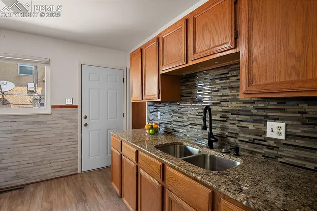 a kitchen with sink cabinets and stove
