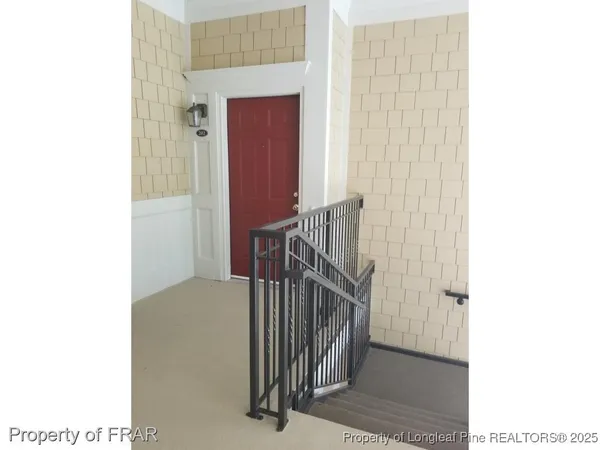 a view of staircase with white walls