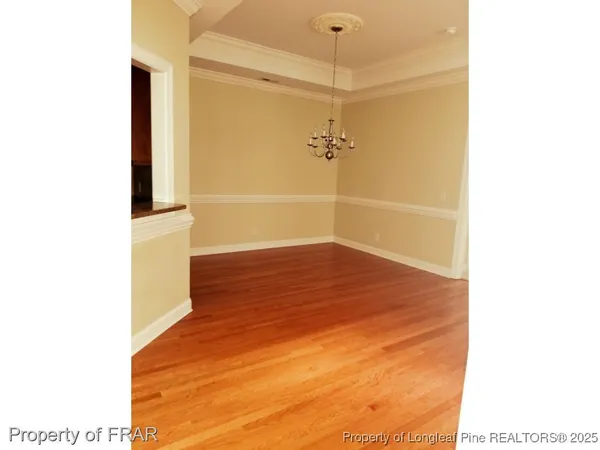 a view of a room with wooden floor