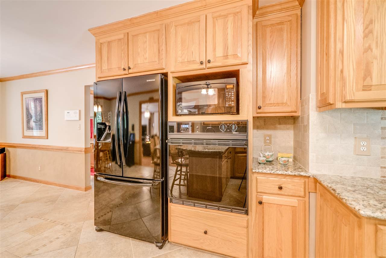 12200 Galway Drive Raleigh, NC 27613 - Photo 3 of 25 Tile Floors, Granite Tops, Nice size break fast. French doors lead out to the wonder deck looking into the woods. Beautiful Spacious Kitchen