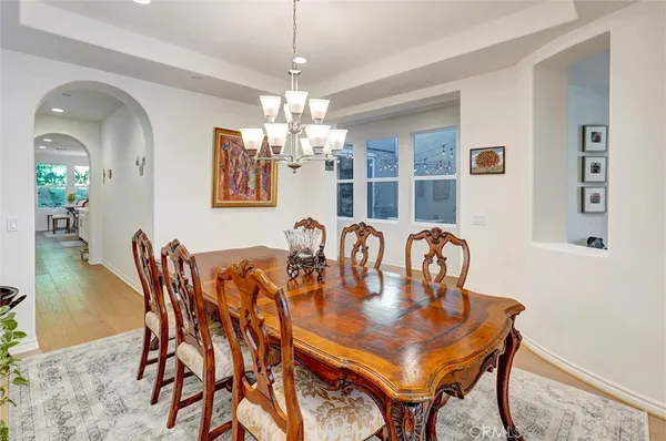 a kitchen with kitchen island a stove a table and chairs in it