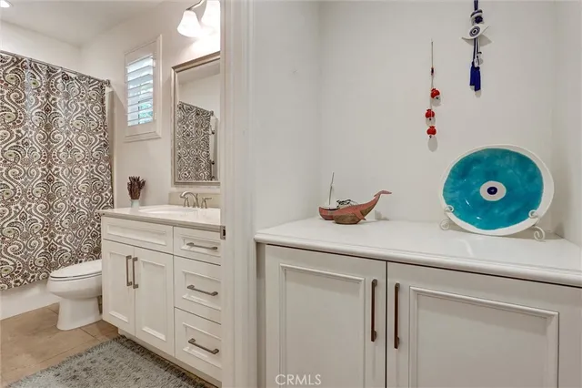 a living room with a rug and a dresser