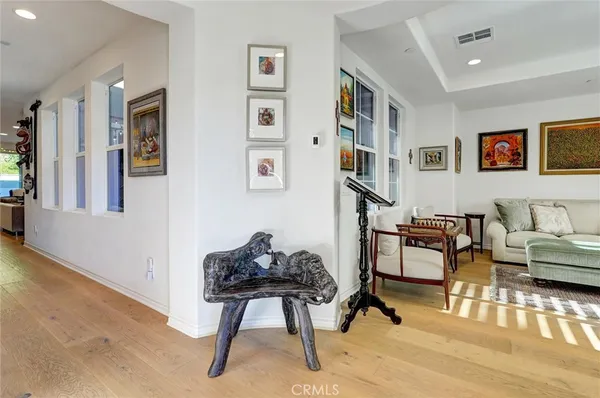 a living room with furniture and painting on the wall