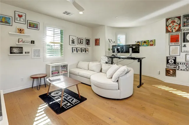 an aerial view of a house with a yard and large trees