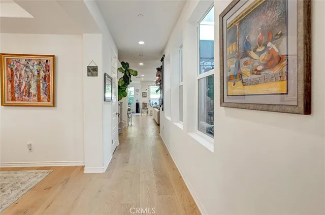 a dining room with furniture a chandelier and wooden floor