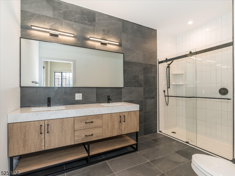 369 Bloomfield Avenue, Unit 2 Montclair, NJ 07042 - Photo 14 of 19 a spacious bathroom with a double vanity sink toilet and shower