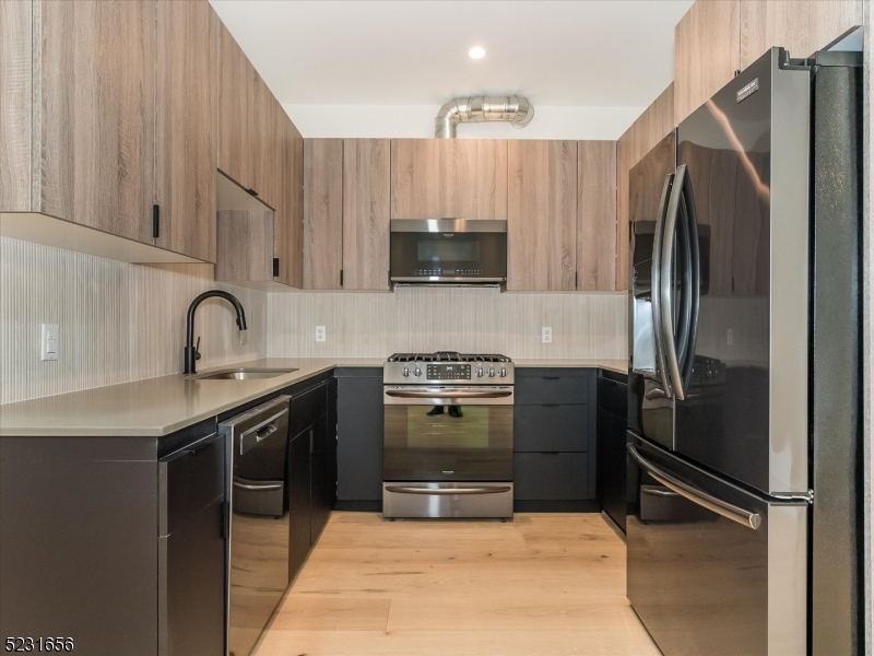 369 Bloomfield Avenue, Unit 2 Montclair, NJ 07042 - Photo 5 of 19 a kitchen with a sink and stainless steel appliances