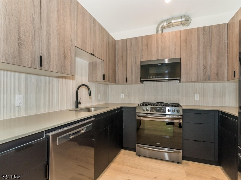 369 Bloomfield Avenue, Unit 2 Montclair, NJ 07042 - Photo 6 of 19 a kitchen with a sink and steel appliances