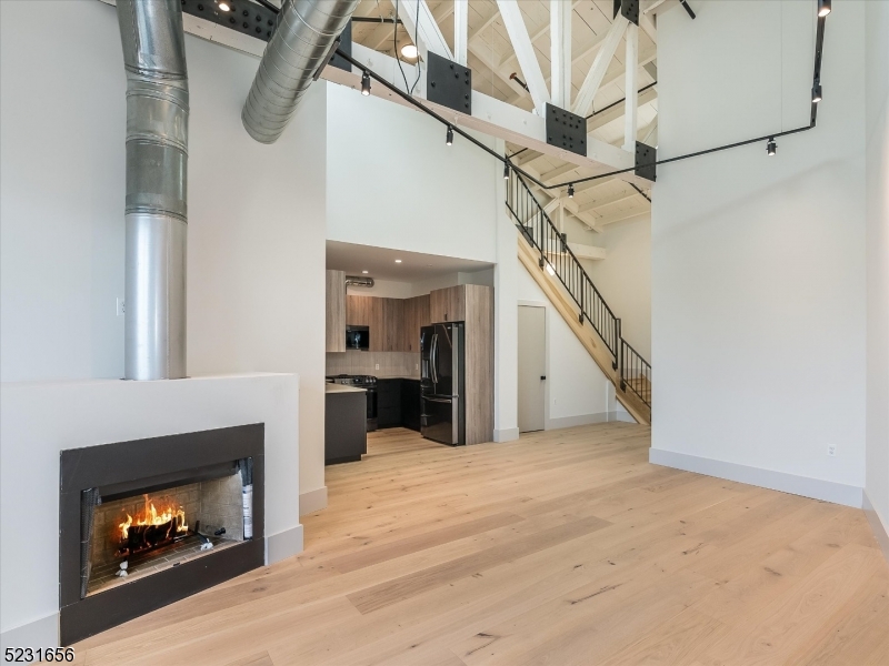 369 Bloomfield Avenue, Unit 2 Montclair, NJ 07042 - Photo 8 of 19 a view of a livingroom with wooden floor fireplace and stairs