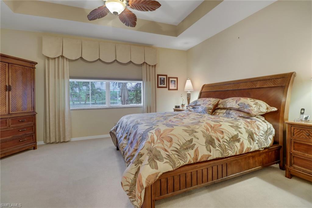 20531 Foxworth Circle Estero, FL 33928 - Photo 12 of 50 Bedroom with ceiling fan, a raised ceiling, and light colored carpet