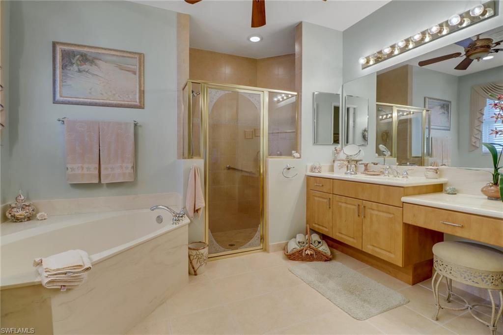 20531 Foxworth Circle Estero, FL 33928 - Photo 15 of 50 Bathroom featuring ceiling fan, tile patterned flooring, independent shower and bath, and vanity