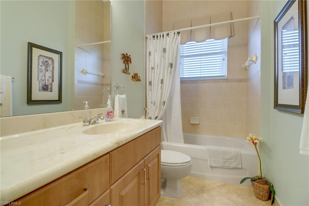 20531 Foxworth Circle Estero, FL 33928 - Photo 20 of 50 Full bathroom featuring tile patterned flooring, toilet, vanity, and shower / bath combo with shower curtain