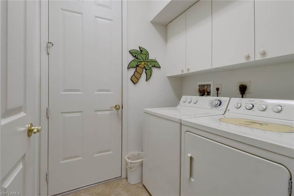 20531 Foxworth Circle Estero, FL 33928 - Photo 21 of 50 Laundry room featuring independent washer and dryer, light tile patterned floors, and cabinets