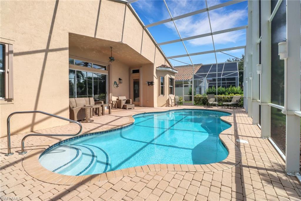 20531 Foxworth Circle Estero, FL 33928 - Photo 22 of 50 View of swimming pool with glass enclosure, a patio, and ceiling fan