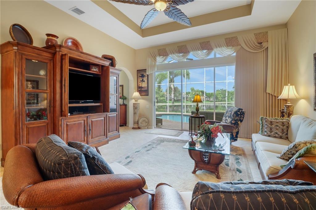 20531 Foxworth Circle Estero, FL 33928 - Photo 4 of 50 Living room with ceiling fan, a raised ceiling, and light tile patterned floors